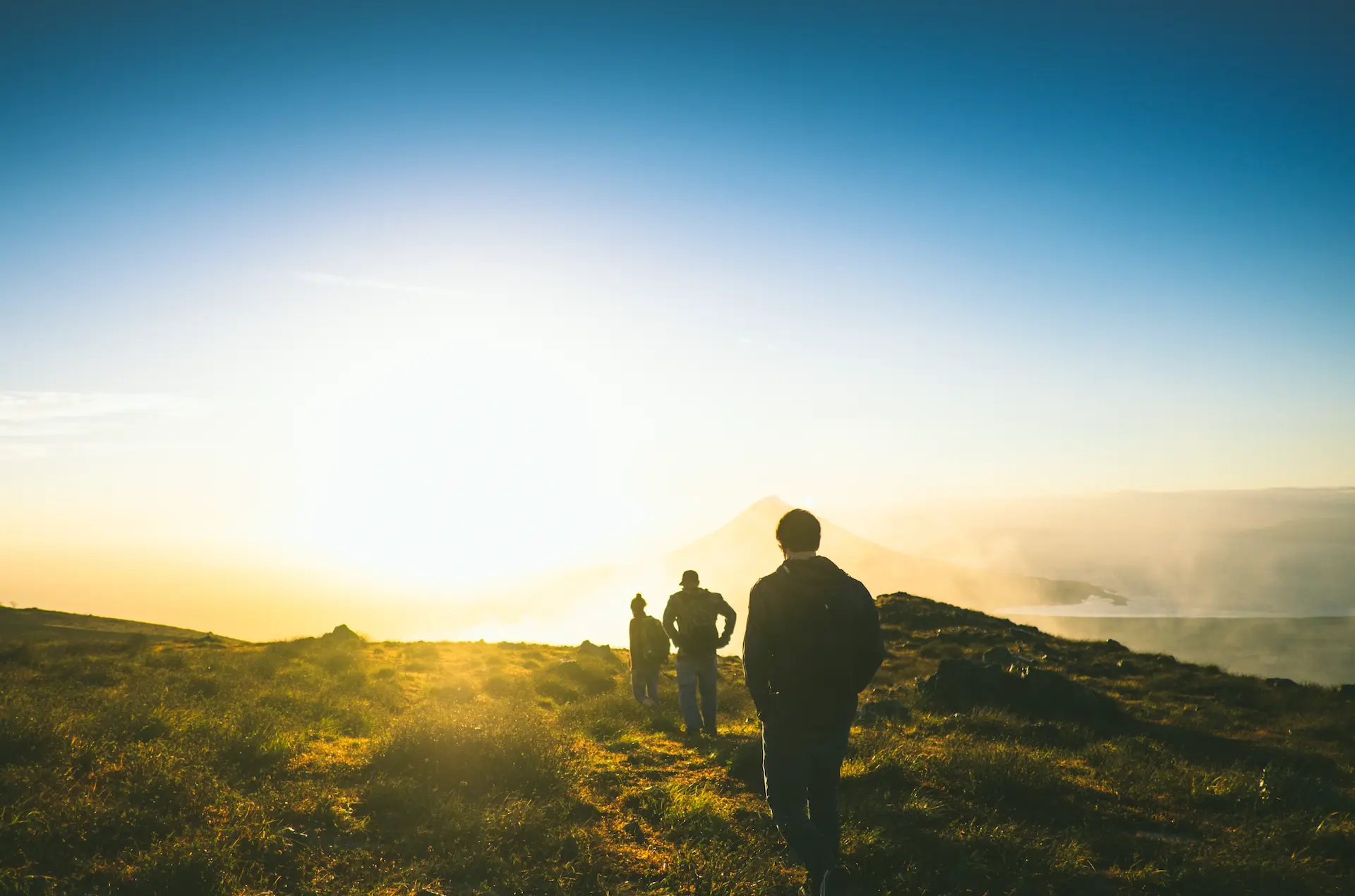 hikers disappearing into the sunset