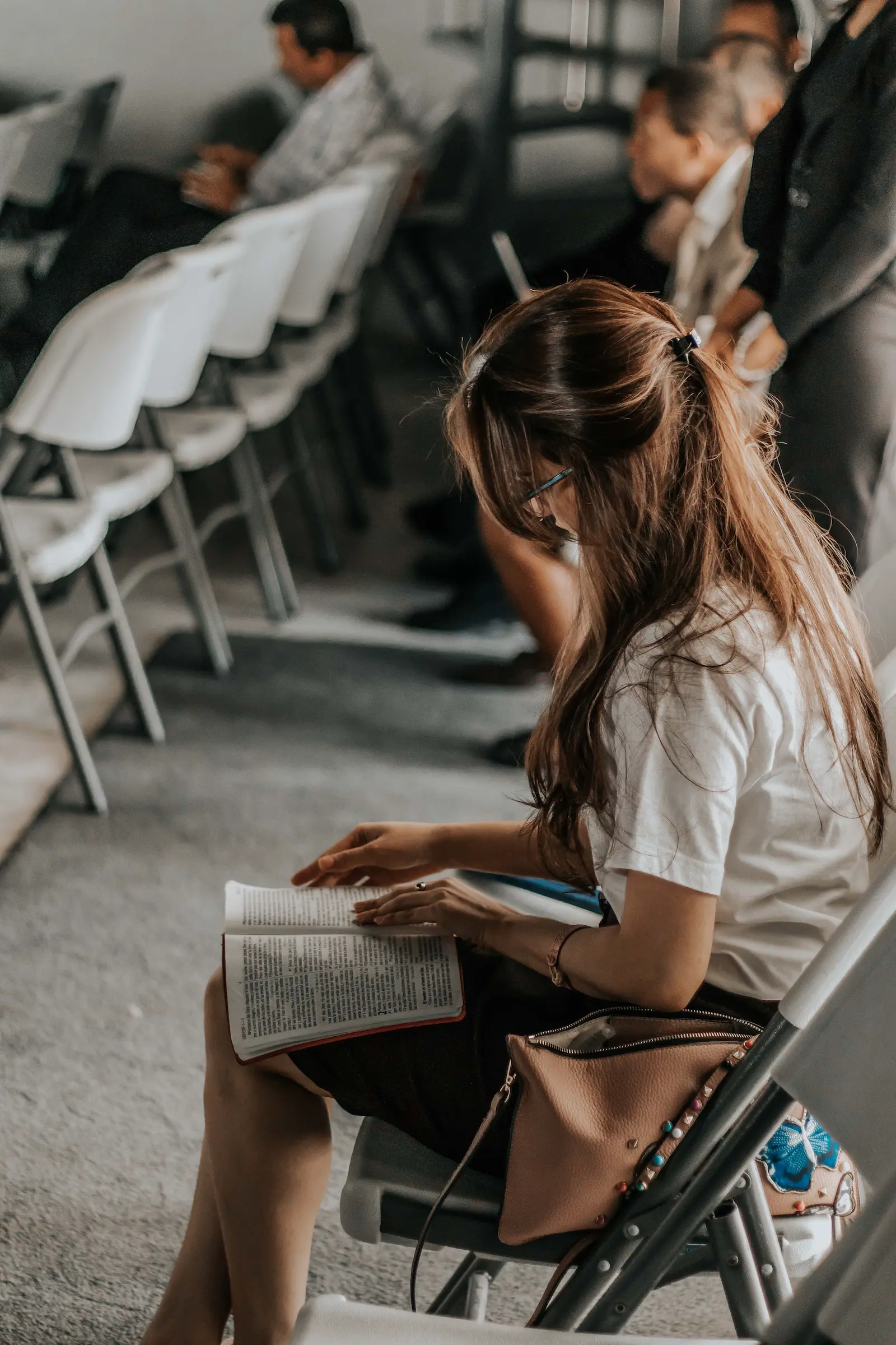 seated woman reading a bible